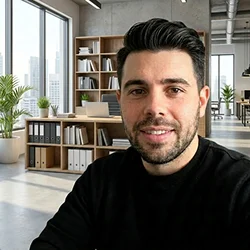 Alex — short dark hair, smiling in office